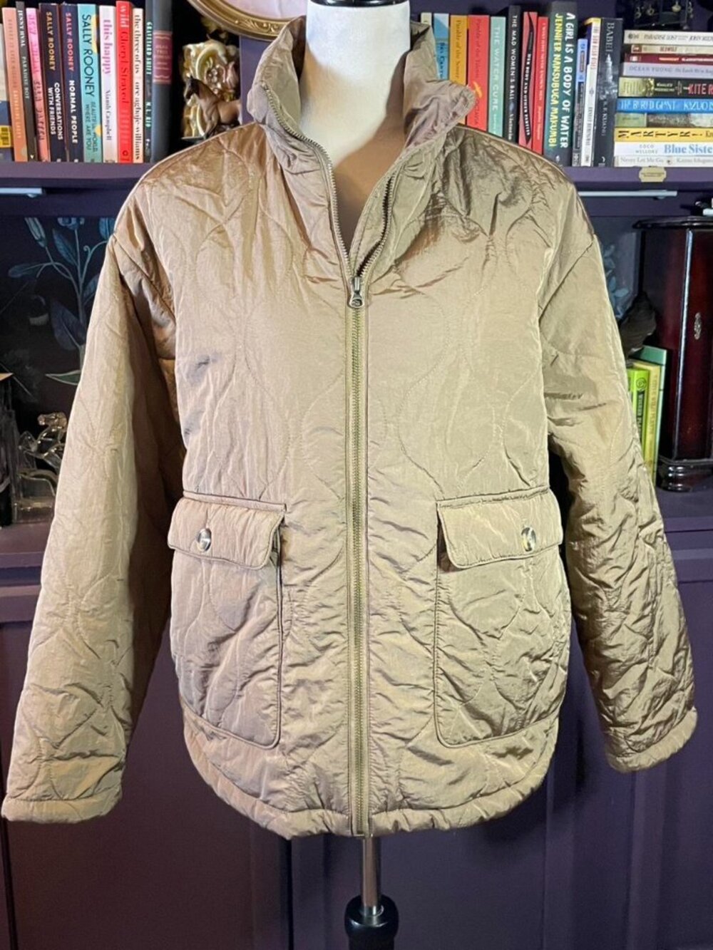 Tan quilted puffer jacket with oversized pockets and zip closure